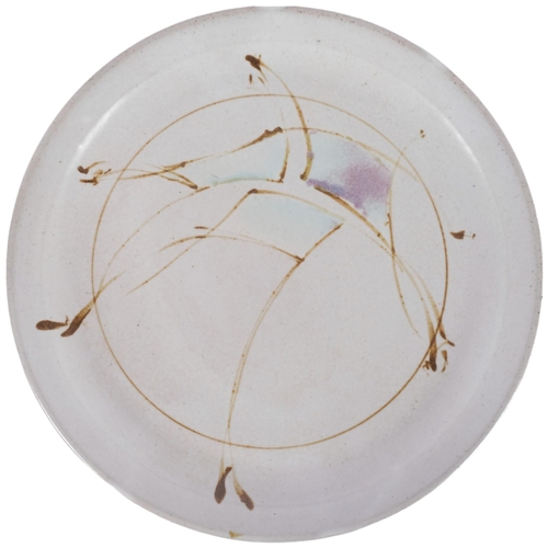 567 - A studio pottery plate with abstract design, signed to base, diameter 28cm