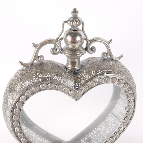 578 - A candle lantern in glazed silvered metal heart-shape frame, H50cm