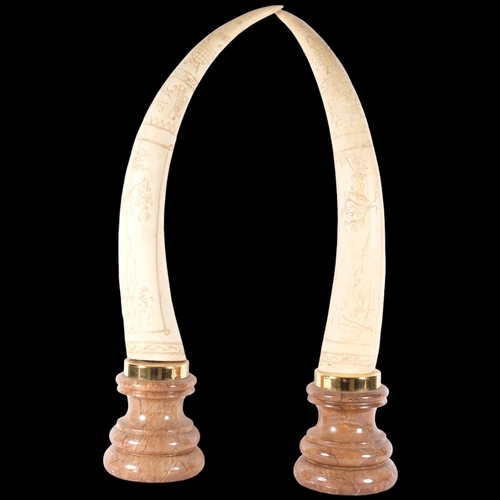 580 - A pair of composition Scrimshaw style tusks on plinths, H76cm