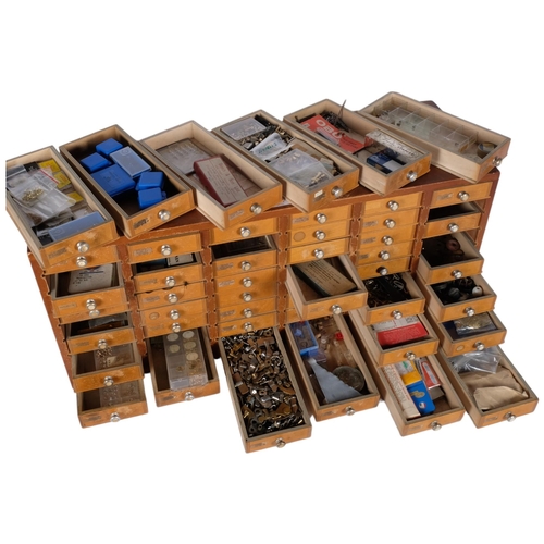 711 - A watchmaker's multi-drawer chest, comprising 48 drawers, complete with various watch parts, winding... 