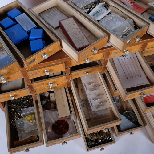 711 - A watchmaker's multi-drawer chest, comprising 48 drawers, complete with various watch parts, winding... 