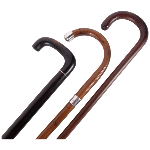 738 - 2 hardwood walking canes and another stick with heavy silver mounts (3)