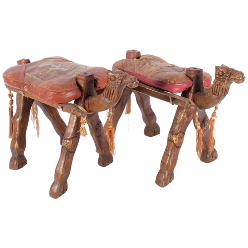 750 - A pair of 2 small wooden camel footstools, with patterned leather cushions, H28cm