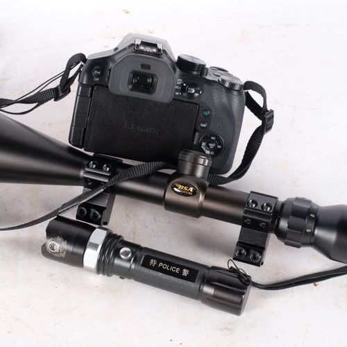 775 - A BSA essential rifle scope, a Japanese policeman's torch, and a Lumix F2.8 camera with Leica lens (... 