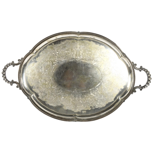 864 - An oval silver plated on brass engraved 2-handled tea tray, width 74cm