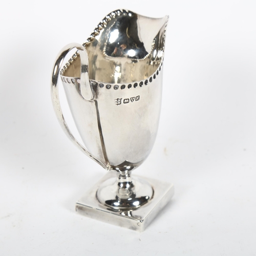 895 - An Edward VII silver cream jug, hallmarks for Chester 1908, maker's marks for Nathan & Hughes, H10cm