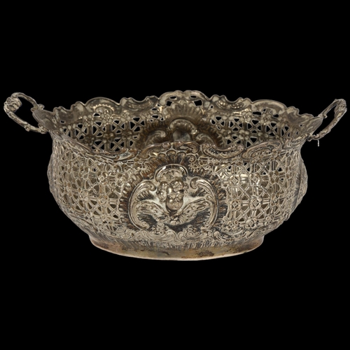 896 - An ornate Victorian silver 2-handled table basket, with allover embossed and pierced decoration, W17... 