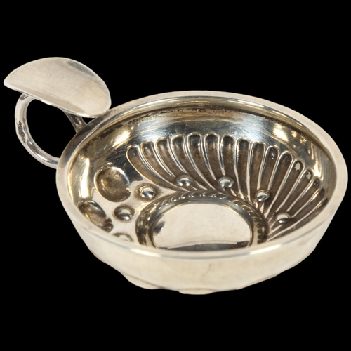 898 - A small French silver wine taster, with relief embossed decoration, indistinct maker's mark, bowl di... 