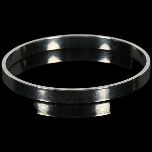 902 - RUDOLF ANDRESEN - a Danish silver plain form slave bangle, band width 6.6mm, internal circumference ... 