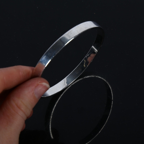 902 - RUDOLF ANDRESEN - a Danish silver plain form slave bangle, band width 6.6mm, internal circumference ... 