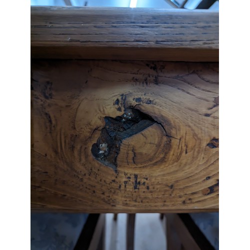 2199 - A French cherry wood and oak plank top dining table, with end frieze drawer and raised on square tap... 