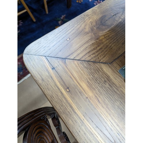 2199 - A French cherry wood and oak plank top dining table, with end frieze drawer and raised on square tap... 