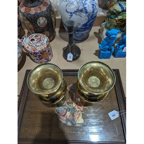 407 - A pair of heavy brass vases on feet, 25.5cm