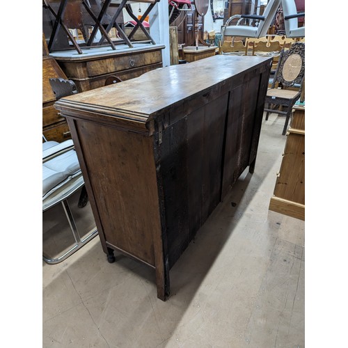 2134 - A mahogany Art Nouveau style sideboard, with four drawers, three cupboards and carved foliate decora... 