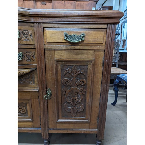 2134 - A mahogany Art Nouveau style sideboard, with four drawers, three cupboards and carved foliate decora... 