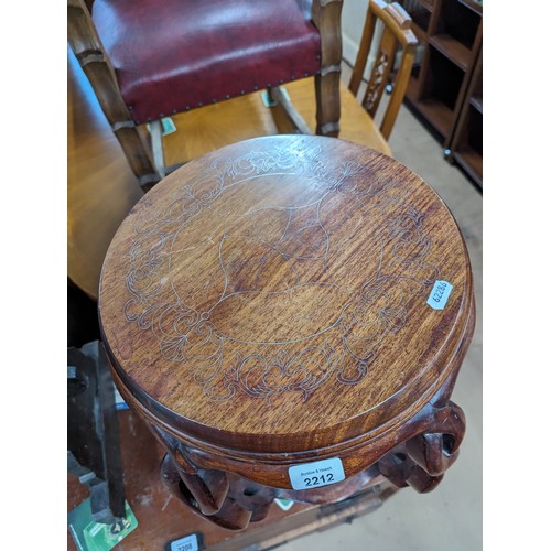 2212 - A Chinese hardwood barrel plant stand, the top having inlaid white metal decoration. 39x45cm.