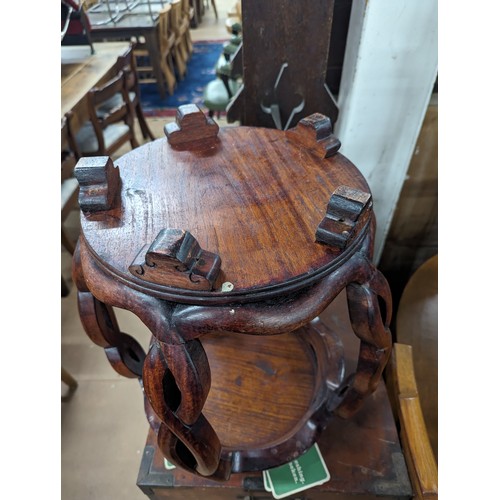 2212 - A Chinese hardwood barrel plant stand, the top having inlaid white metal decoration. 39x45cm.