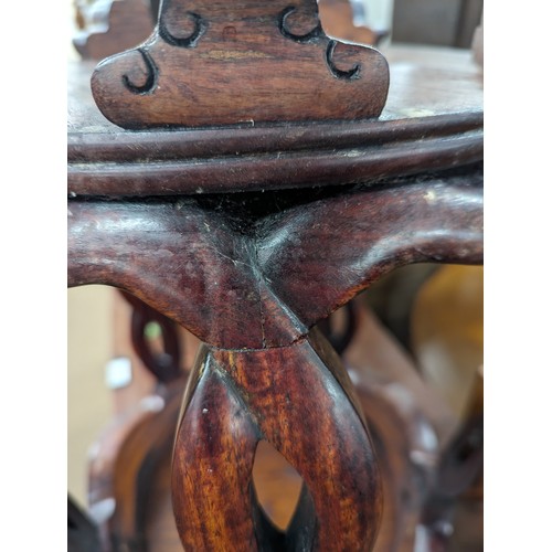 2212 - A Chinese hardwood barrel plant stand, the top having inlaid white metal decoration. 39x45cm.