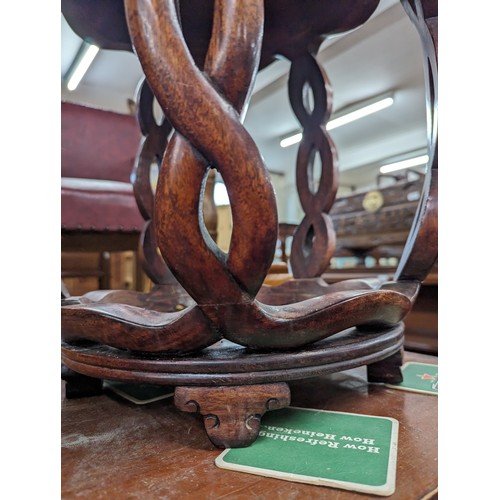 2212 - A Chinese hardwood barrel plant stand, the top having inlaid white metal decoration. 39x45cm.