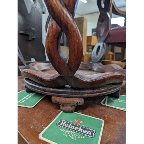 2212 - A Chinese hardwood barrel plant stand, the top having inlaid white metal decoration. 39x45cm.