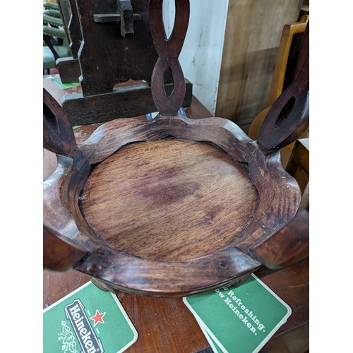 2212 - A Chinese hardwood barrel plant stand, the top having inlaid white metal decoration. 39x45cm.