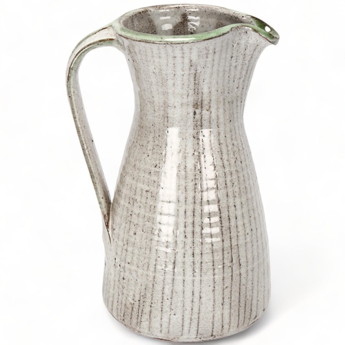 103 - DAVID LEACH (1911-2005), British, a grey and green glaze jug with sgraffito lines, makers mark to ba... 