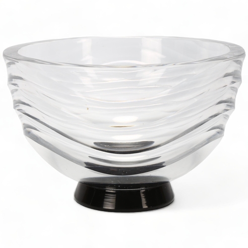 162 - SIMON GATE for Orrefors, Sweden, a 1930s' clear glass wave pattern vase on black foot, marked to bas... 