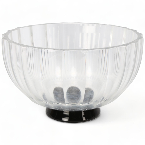 164 - VICKE LINDSTRAND for Orrefors, Sweden, a 1930s' clear glass ribbed bowl on black foot, marked to bas... 