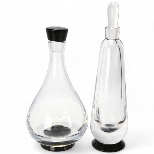 186 - EDWARD HALD for Orrefors, Sweden, two decanters with black foot, both marked to base Orrefors, slim ... 