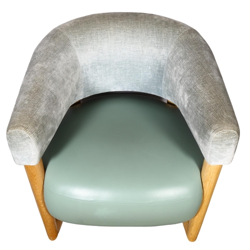 72 - Manner of Jean Royere, a green leather and velvet unholstered, oak frame lounge chair on sled base, ... 