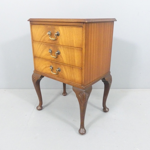 2108 - A continental style crossbanded mahogany and walnut three-drawer bedside chest, with cabriole legs a... 