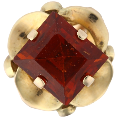 1102 - A late 20th century hessonite garnet dress ring, unmarked gold set with 9ct rectangular step-cut gar... 