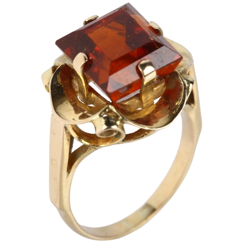 1102 - A late 20th century hessonite garnet dress ring, unmarked gold set with 9ct rectangular step-cut gar... 