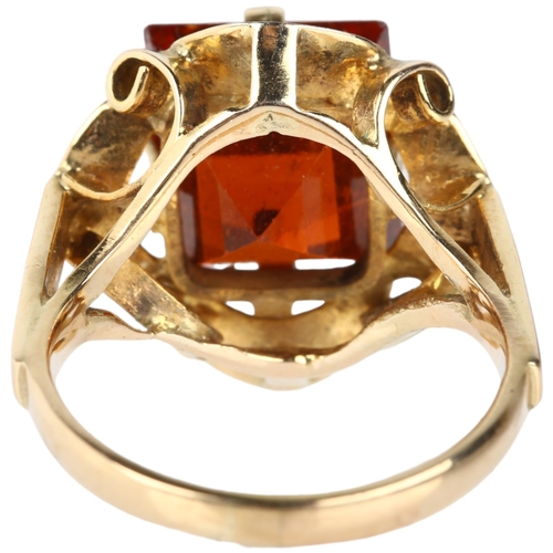 1102 - A late 20th century hessonite garnet dress ring, unmarked gold set with 9ct rectangular step-cut gar... 