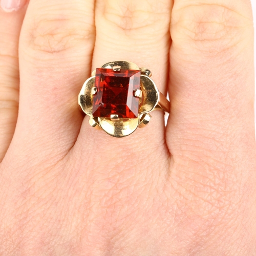 1102 - A late 20th century hessonite garnet dress ring, unmarked gold set with 9ct rectangular step-cut gar... 