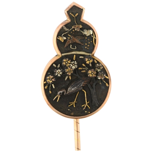 1103 - A Japanese Meiji Period Shakudo 'Crane and Blossom' stickpin, 3-colour gold decoration, unsigned, he... 