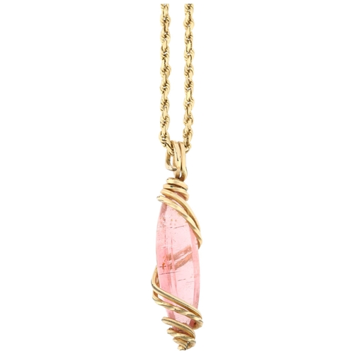 1106 - A Continental pink tourmaline pendant necklace, the long marquise-cut tourmaline within wirework fra... 