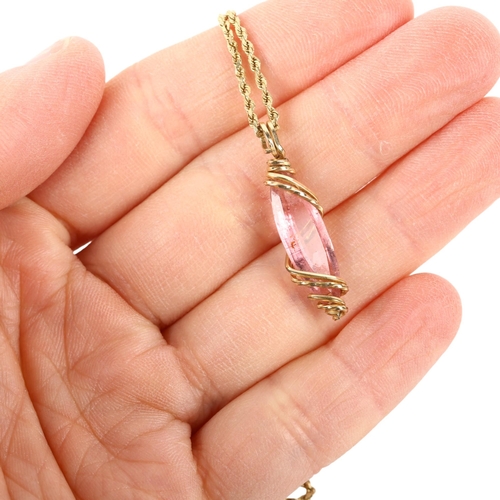 1106 - A Continental pink tourmaline pendant necklace, the long marquise-cut tourmaline within wirework fra... 