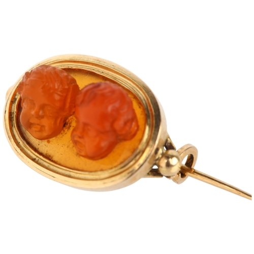 1111 - An Antique carnelian high relief double putti head cameo brooch, probably Italian, frame apparently ... 