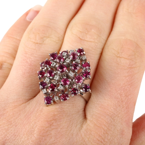 1114 - A large 18ct white gold ruby and diamond marquise cluster cocktail ring, claw set with round-cut rub... 