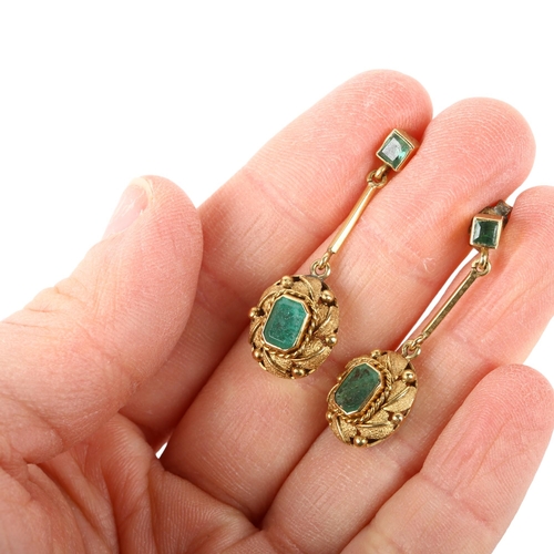 1115 - A pair of emerald drop earrings, late 20th century, rub-over set with octagonal and square step-cut ... 