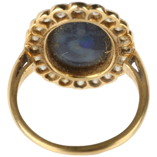 1130 - A black opal and diamond oval cluster ring, mid-20th century, rub-over set with 2.5ct oval cabochon ... 