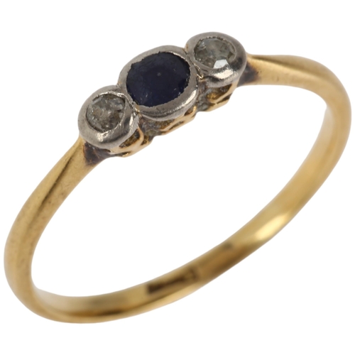 1143 - An early 20th century 18ct gold three stone sapphire and diamond ring, total diamond content approx ... 