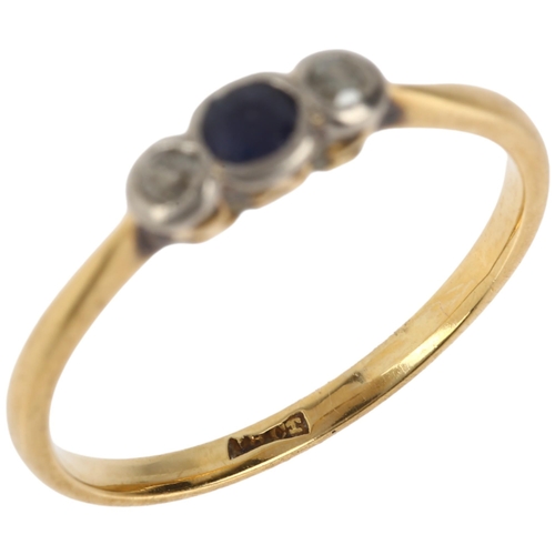 1143 - An early 20th century 18ct gold three stone sapphire and diamond ring, total diamond content approx ... 