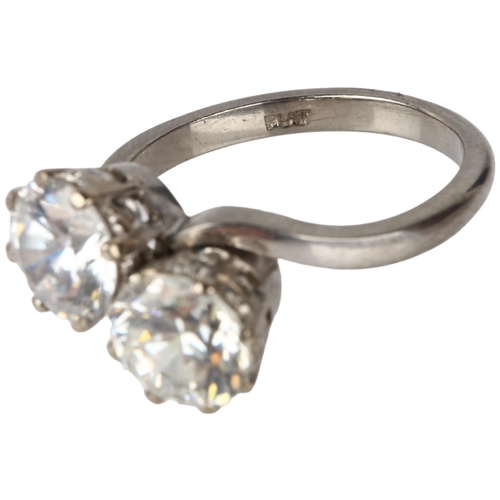 1154 - An early 20th century platinum two stone cubic zirconia crossover ring, cubic zirconia measure appro... 