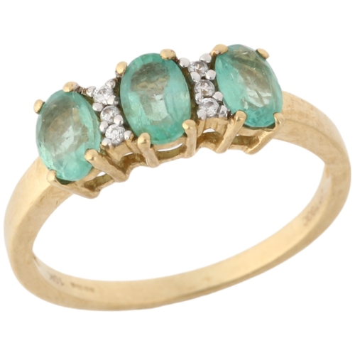 1162 - A modern 9ct gold emerald and cubic zirconia half hoop ring, claw set with oval mixed-cut emeralds a... 