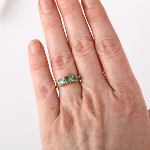 1162 - A modern 9ct gold emerald and cubic zirconia half hoop ring, claw set with oval mixed-cut emeralds a... 