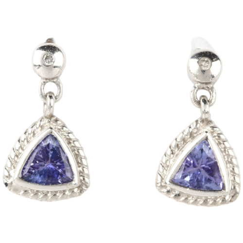 1163 - A pair of 9ct white gold tanzanite drop earrings, rub-over set with trillion-cut tanzanites, with st... 