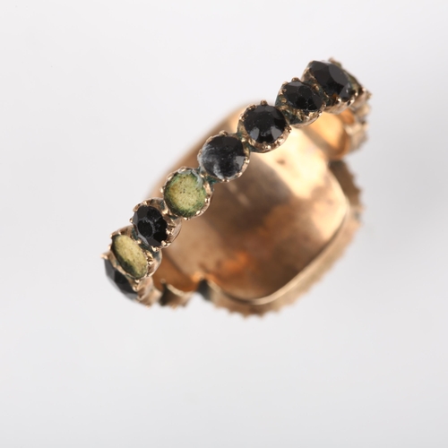 1179 - A Georgian jet mourning ring, circa 1820, the central moire silk panel beneath convex glass, within ... 