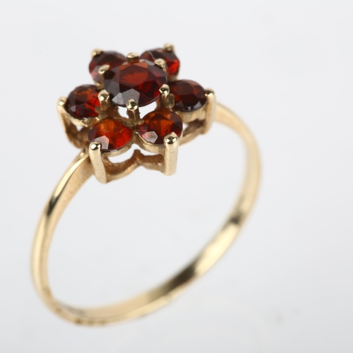 1180 - A 9ct gold garnet flowerhead cluster ring, London 1979, setting height 10.7mm, size P, 1.7g